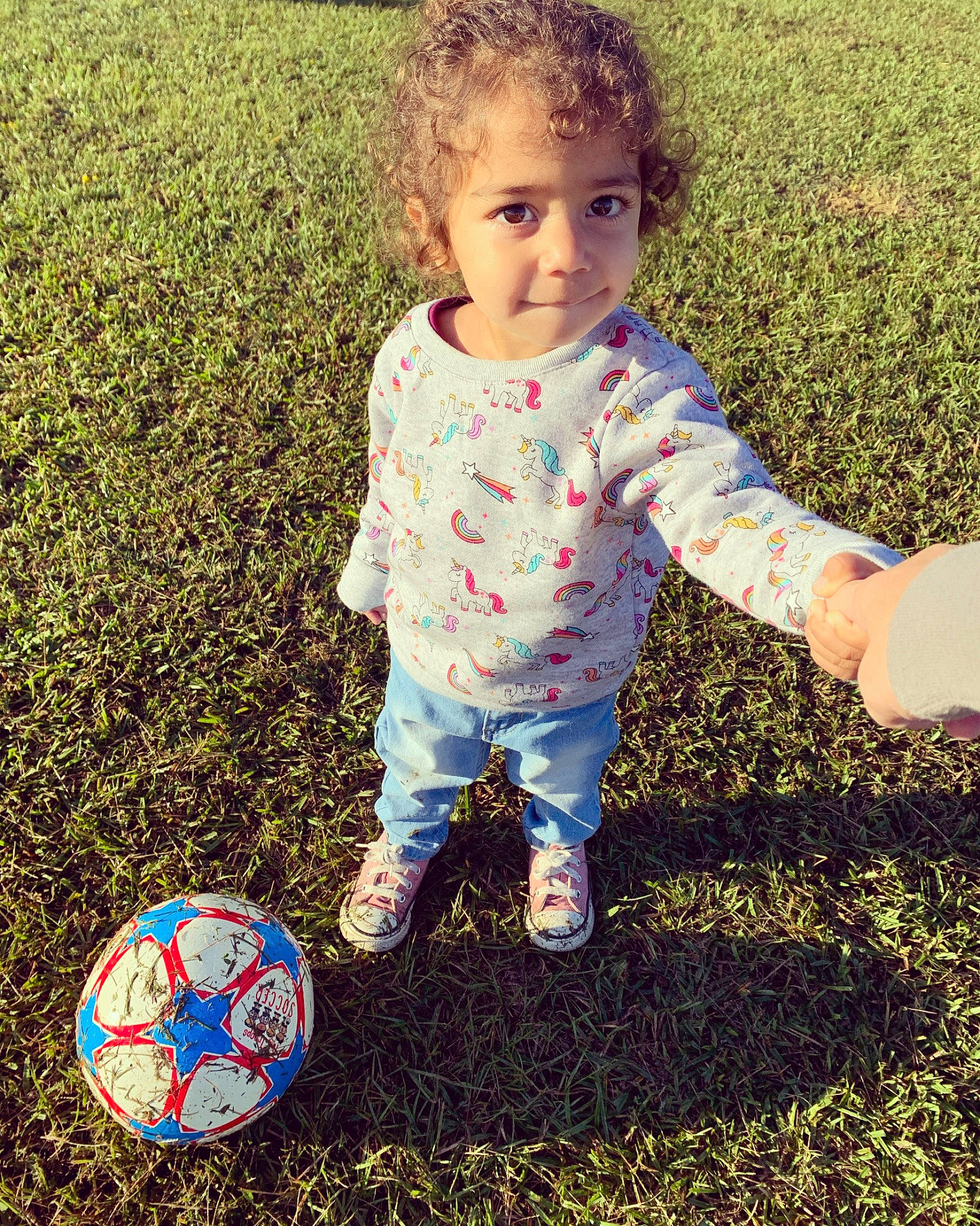Meena is registered to the contest to win money with this photo: baby, baby_toddler_clothing, ball, child, football, grass, happy, lawn, pattern, person, plant, play, playing_with_kids, soccer_ball, t_shirt, toddler