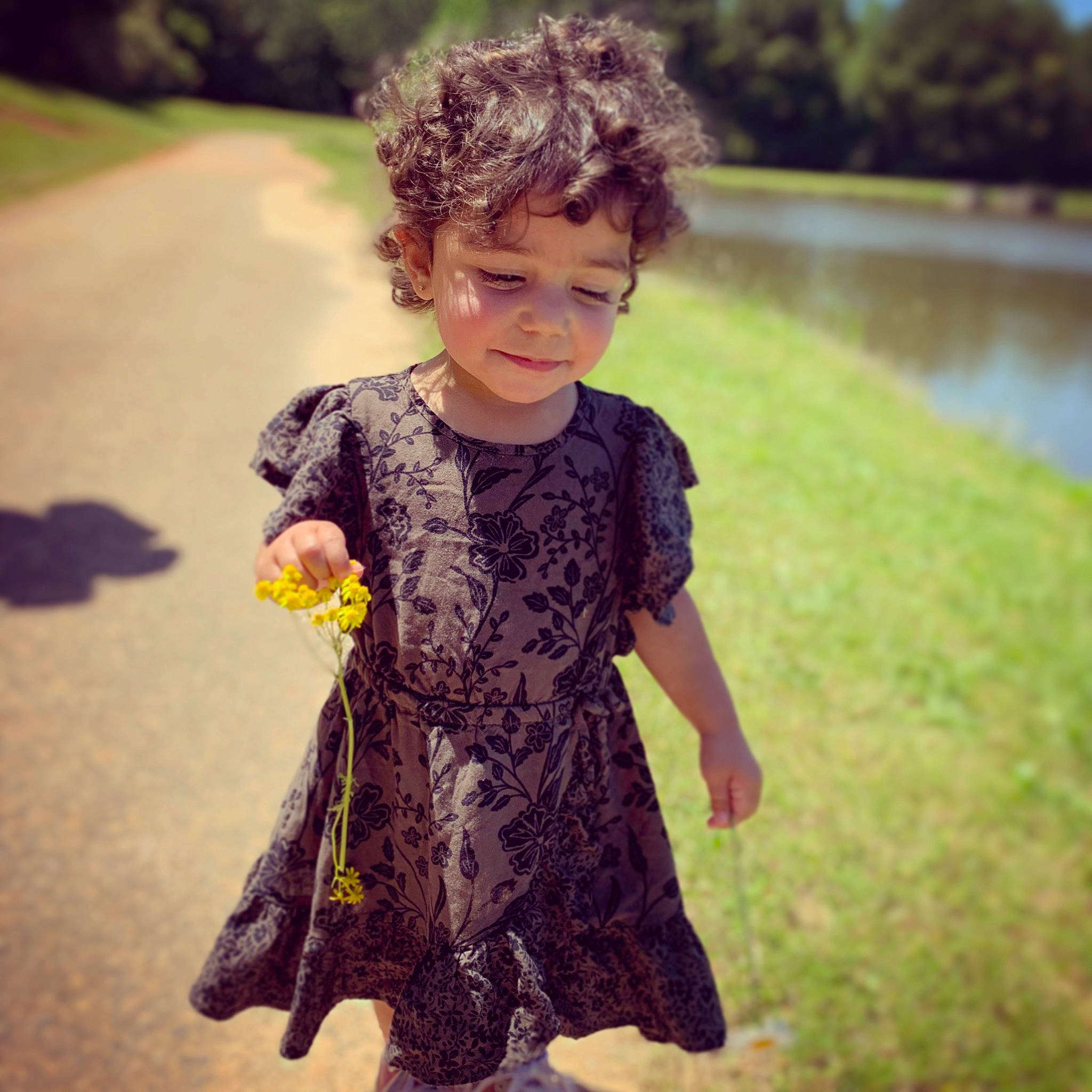 Meena is registered to the contest to win money with this photo: child, clothing, cool, dress, fashion, happy, outerwear, pattern, person, photography, plant, play, sleeve, smile, spring, standing, summer, t_shirt, textile, toddler