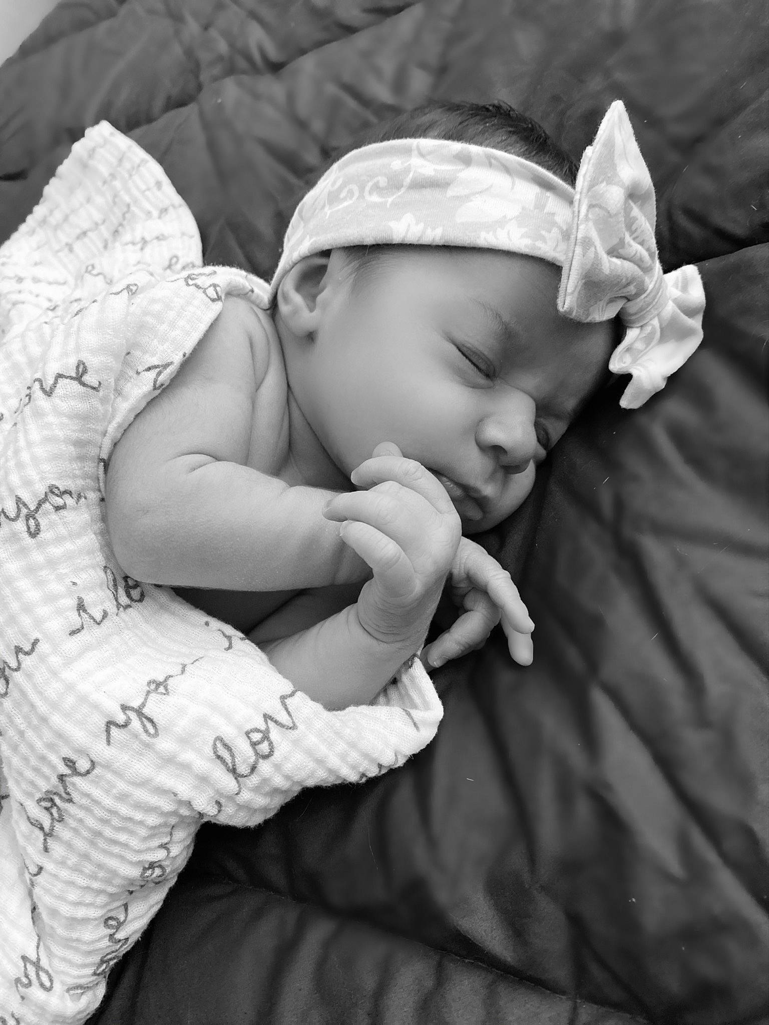 Olivia is registered to the contest to win money with this photo: baby, birth, black_and_white, child, hand, headwear, monochrome_photography, person, photograph, photography, portrait_photography, sleep, style, toddler