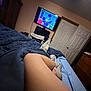 Muffin joined the competition — help win amazing prizes! bedroom, bed, legs, person, dog, television, cartoon, donald_duck, blanket, socks, dresser, door, furniture, relaxing, indoor, watching_tv, blue, white, wood, comfort