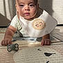 Soan participe au concours pour gagner de l'argent avec cette photo : baby, infant, bib, pacifier, play_mat, sunlight, shadow, patterned_mat, crawling, clothing, indoor, child, cute, face, head, expression, skin, floor, texture, person