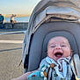 Soan participe au concours pour gagner de l'argent avec cette photo : baby, stroller, smiling, toy, pacifier, outdoor, daylight, water, people, happy, child, clothing, blanket, accessory, park, sunlight, person, face, relaxing, nature