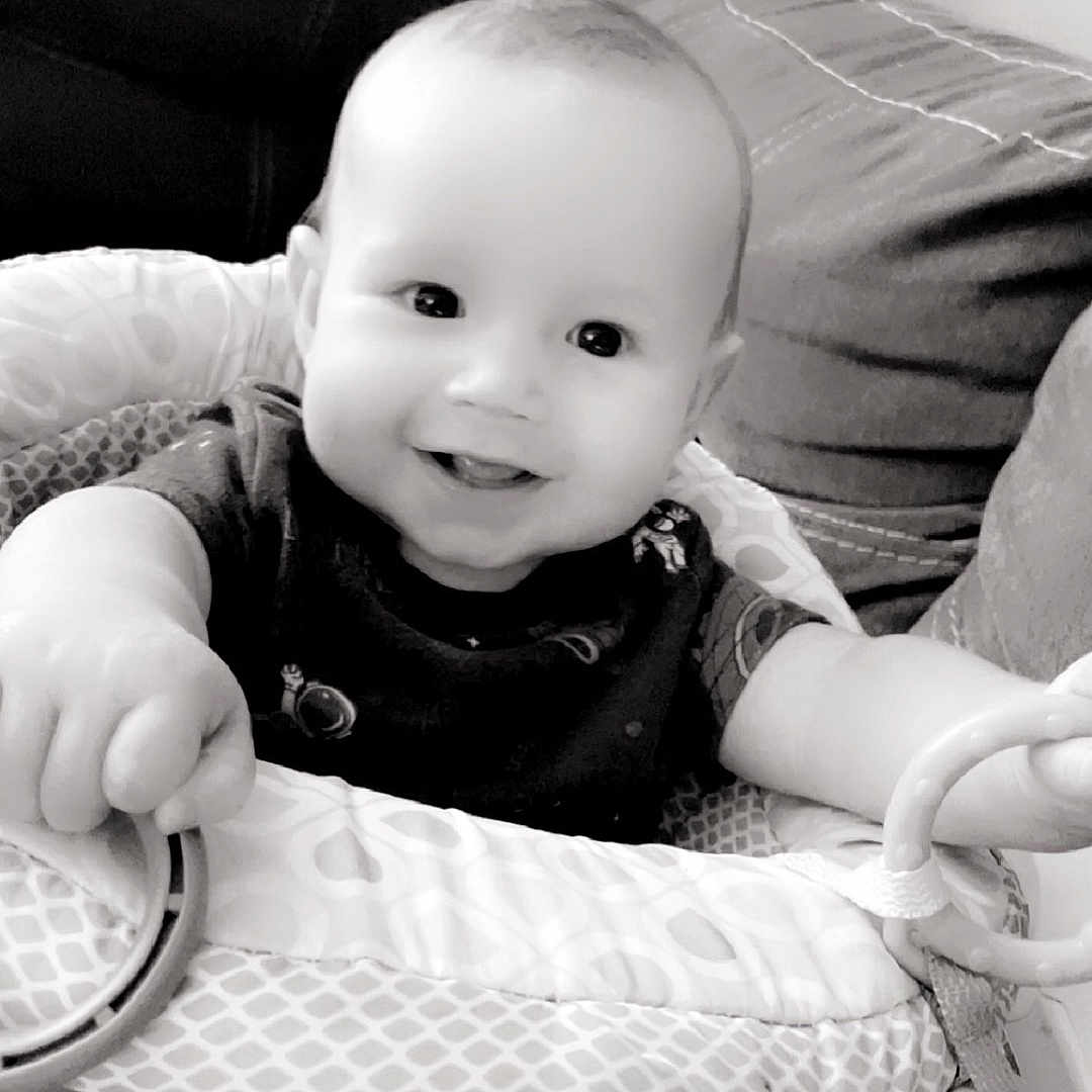 Armani is registered to the contest to win money with this photo: accessories, baby, bed, bodypart, clothing, couch, cushion, face, finger, furniture, hand, head, homedecor, indoors, newborn, person, photography, portrait, shorts, sitting