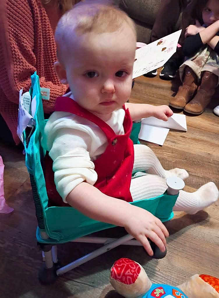 Kierstleigh joined the competition — help win amazing prizes! toddler, child, indoor, chair, red_clothing, white_tights, wooden_floor, person, sitting, toy, serious_expression, boots, floor, seated, furniture, people, background, hand, baby, young_child