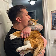 Baboo joined the competition — help win amazing prizes! man, cat, tattoo, indoor, door, light, orange_cat, white_cat, holding, affection, pet, animal, feline, human, portrait, wall, sign, expression, close_up, casual