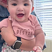 Eliora is registered to the contest to win money with this photo: baby, child, smiling, headband, floral, pink_shirt, denim_jacket, adult, watch, hand, window_blinds, daylight, indoor, cute, happy, skin, face, person, clothing, portrait