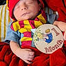 baby, child, clothing, cute, fabric, face, hand, hat, indoors, infant, milestone_sign, one_month, person, portrait, red_blanket, resting, scarf, sleeping, soft_lighting, winnie_the_pooh