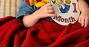Jiren joined the competition — help win amazing prizes! baby, child, cozy, cute, feet, hands, harry_potter_hat, indoors, infant, milestone_card, newborn, one_month, peaceful, portrait, red_blanket, scarf, sleeping, soft_lighting, striped_bed, wrapped