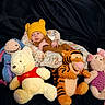 baby, child, cozy, cushion, cute, eeyore, floral_pattern, indoor, infant, knit_hat, piglet, plush_toys, pooh, portrait, resting, soft_toys, stuffed_animals, tigger, winnie_the_pooh, yellow_hat