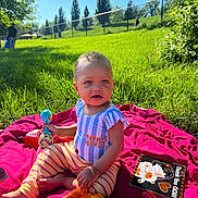 Olaya Avant joined the competition — help win amazing prizes! child, toddler, toy, blanket, grass, outdoor, sunny, park, greenery, person, playtime, colorful, clothing, baby, nature, daylight, smiling, sitting, cute, recreation