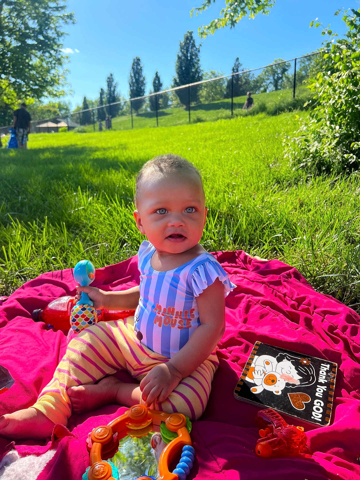Olaya Avant joined the competition — help win amazing prizes! child, toddler, toy, blanket, grass, outdoor, sunny, park, greenery, person, playtime, colorful, clothing, baby, nature, daylight, smiling, sitting, cute, recreation