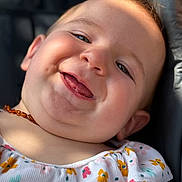 Sophia a rejoint le concours — aidez-le/la à gagner de superbes lots ! baby, child, smiling, tongue_out, close_up, face, cheeks, necklace, floral_dress, sunlight, happy, cute, portrait, infant, skin, head, young_child, sitting, colorful, warm_light