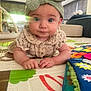 baby, child, clothing, colorful, couch, curious, decor, expression, face, floor, hands, headband, indoor, play_mat, portrait, smiling, soft_light, toy, window, young_child