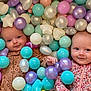 Madison And Melanie joined the competition — help win amazing prizes! baby, infant, child, play, colorful, balls, pastel_colors, smile, cute, face, leopard_print, floral_print, pajamas, indoor, fun, happy, skin, head, hand, eyes