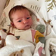 Annabelle is registered to the contest to win money with this photo: baby, newborn, blanket, teddy_bear, pacifier, bed, bedding, woodland, animal_print, infant, cute, soft, sleeping_area, child, face, person, resting, cozy, clothing, indoors