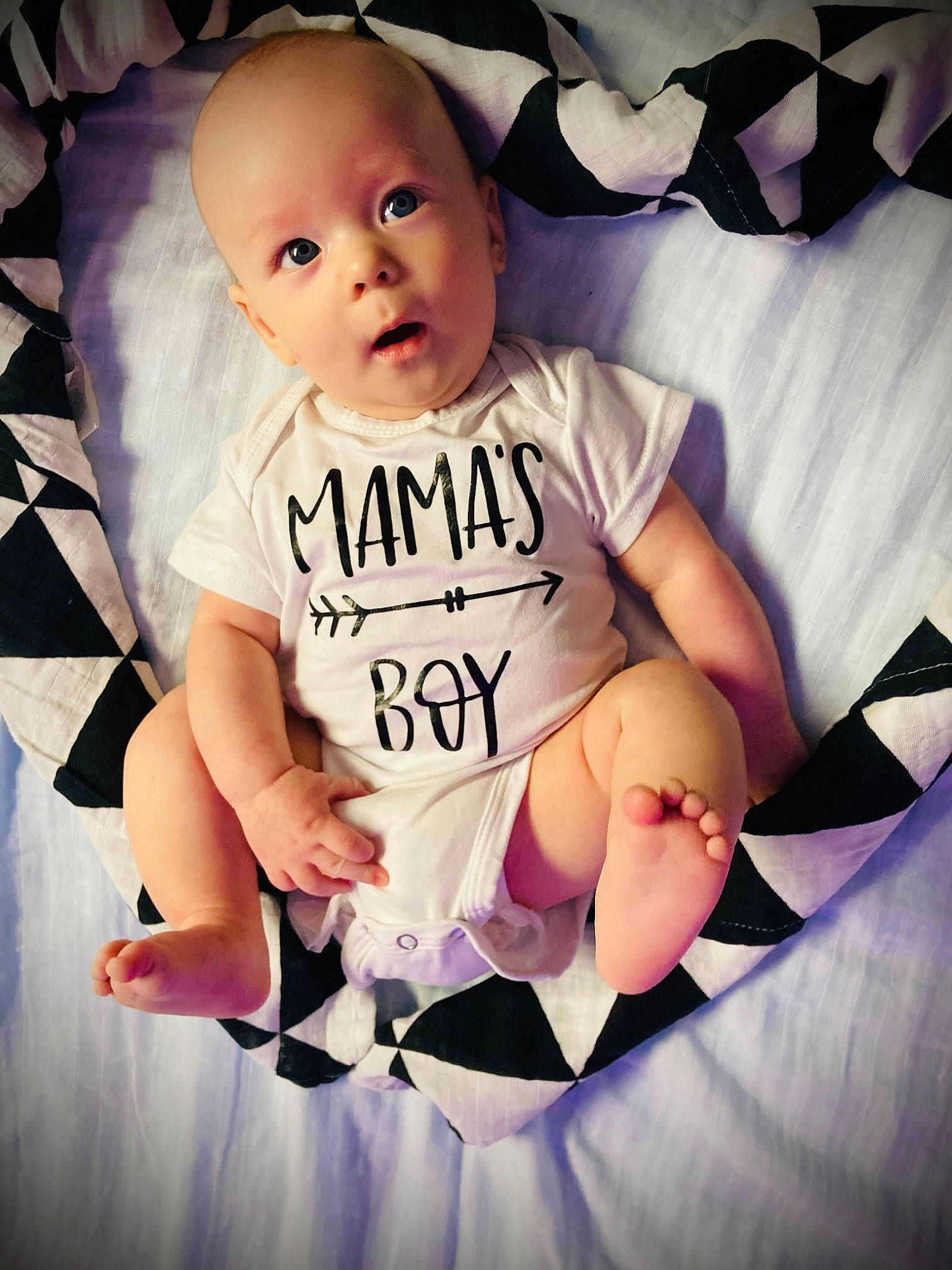 Gideon is registered to the contest to win money with this photo: arm, baby, baby_toddler_clothing, child, cool, finger, flash_photography, font, fun, happy, head, linens, pattern, person, pink, purple, sitting, sleeve, t_shirt, toddler