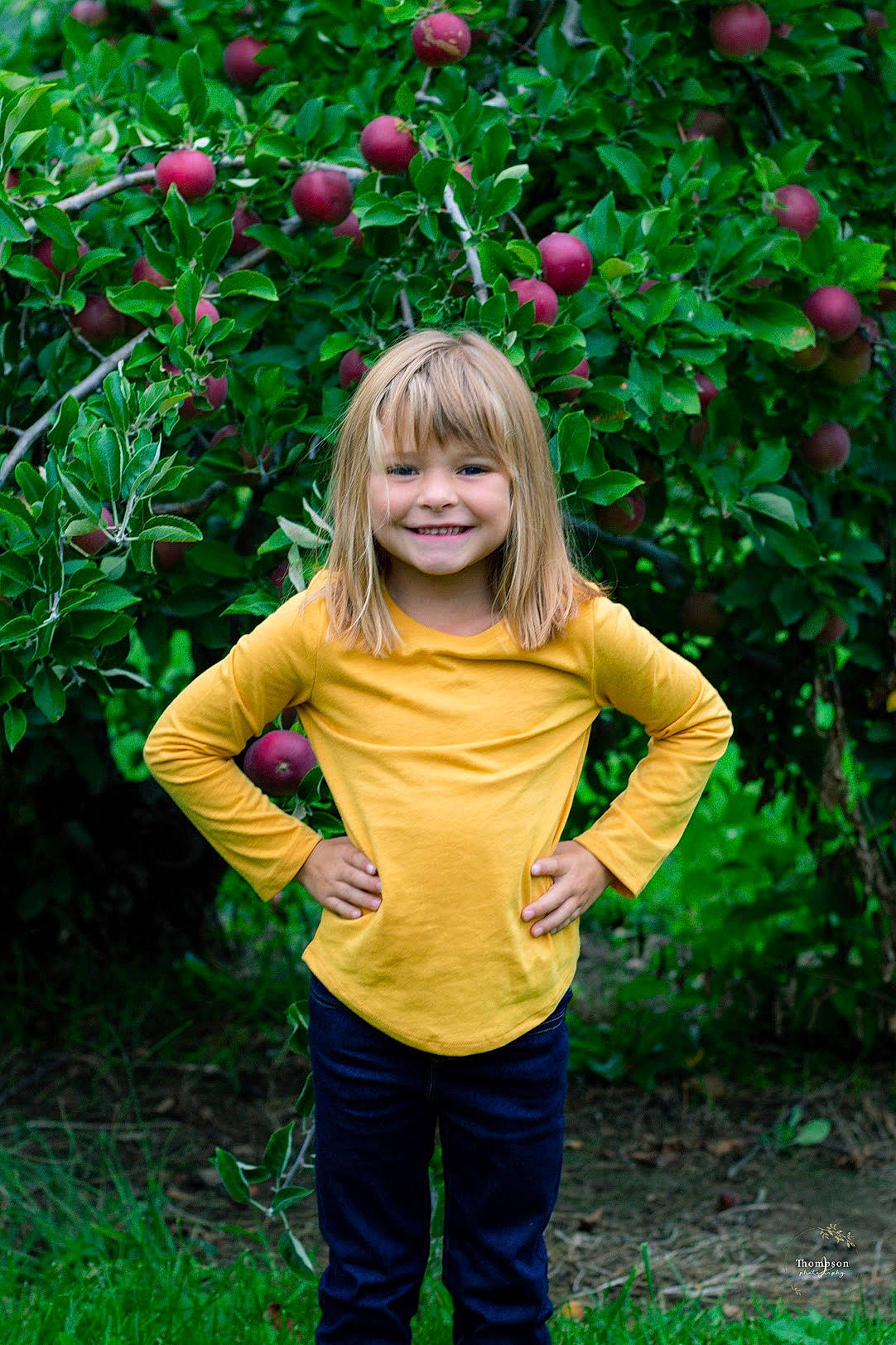 Madaelyn is registered to the contest to win money with this photo: apple, blond, botany, child, child_model, flower, fun, grass, green, happy, joy, leaf, people_in_nature, person, photography, pink, plant, rose_family, smile, toddler