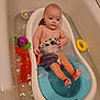 baby, bathtub, water, toy, bathroom, child, infant, bath, floating_toy, plastic, toddler, skin, naked_upper_body, sitting, bath_toy, yellow_ring, purple_towel, blue_bathtub_insert, cute, relaxing