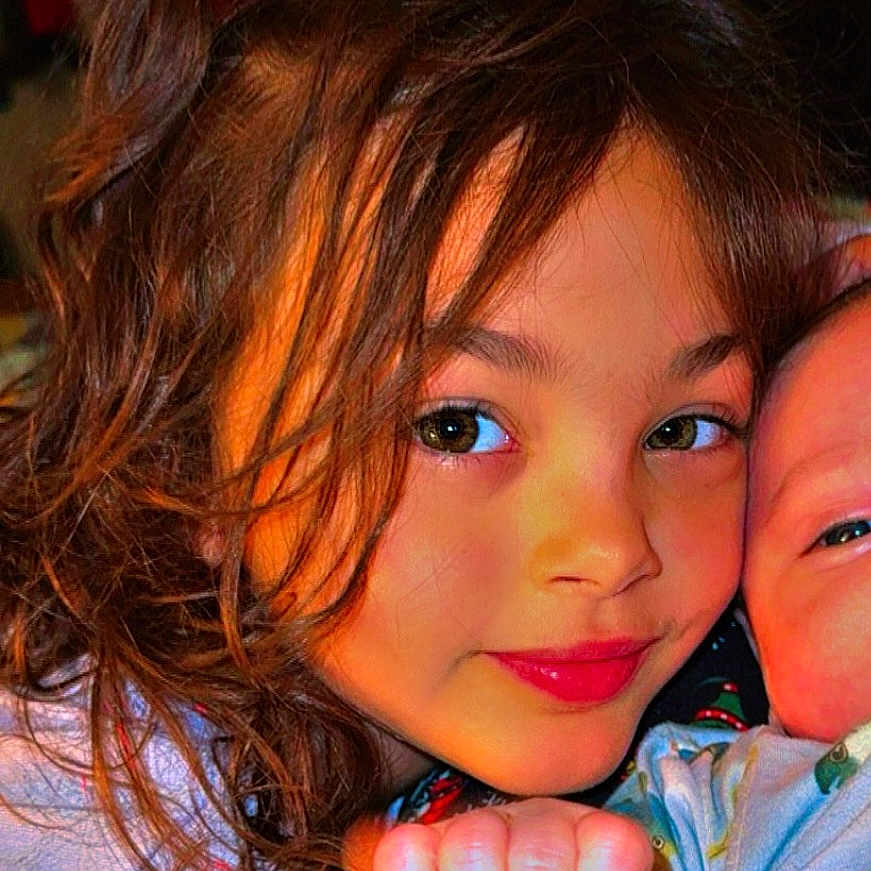 Tynlee joined the competition — help win amazing prizes! baby, child, closeup, curly_hair, cute, expression, face, family, fish_pattern, hand, holding_hand, holiday_outfit, indoor, infant, pajamas, person, skin, smile, toddler, warm_lighting