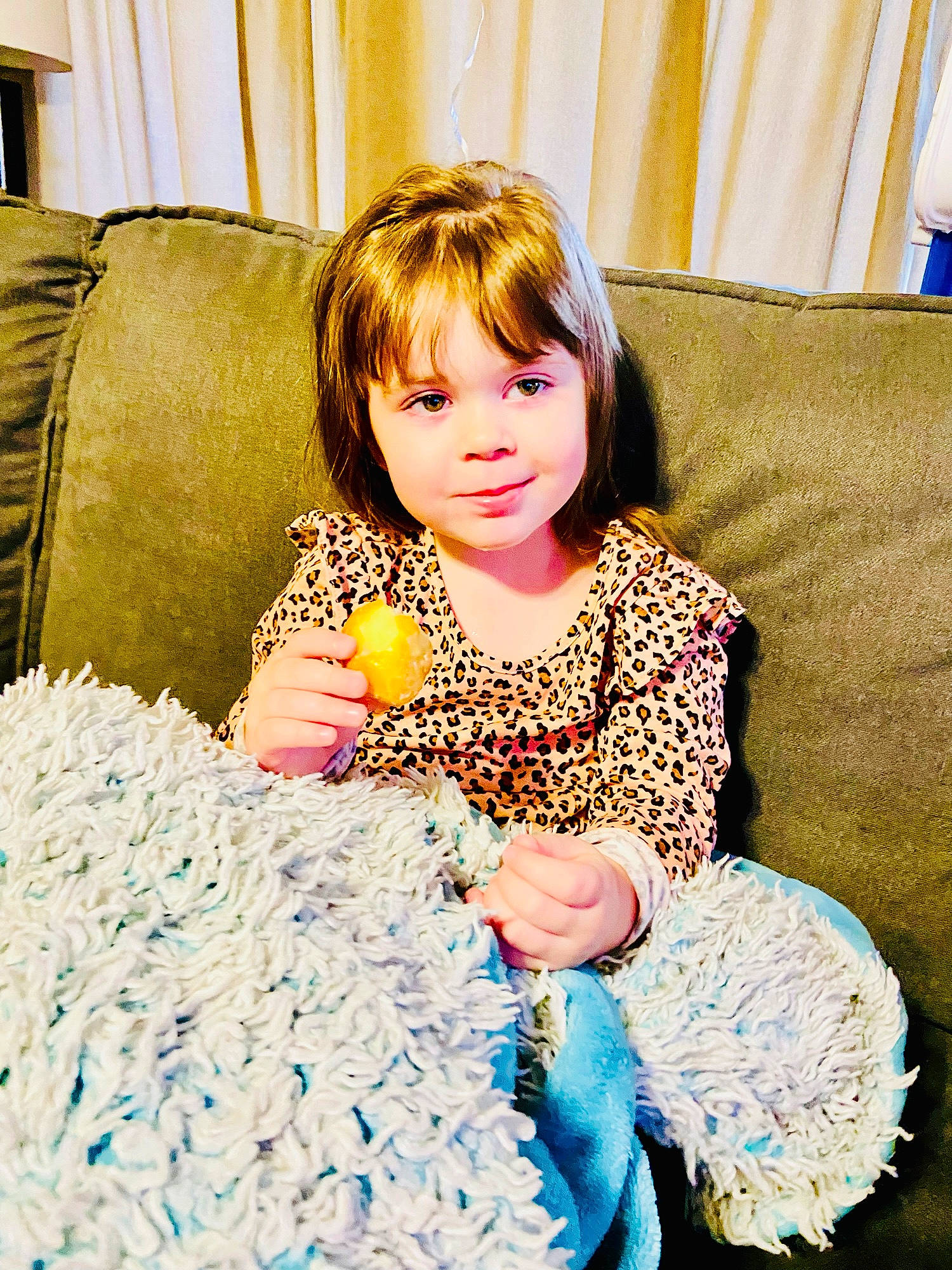 Poppy is registered to the contest to win money with this photo: azure, baby_toddler_clothing, blue, child, comfort, couch, curtain, electric_blue, event, fun, green, hair, happy, linens, living_room, pattern, person, pillow, sitting, textile