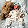 Thaylo a rejoint le concours — aidez-le/la à gagner de superbes lots ! child, baby, newborn, yawning, blue_hat, knitted_outfit, white_socks, teddy_bear, stuffed_animal, pillow, blanket, bed, cozy, cute, tiny_hands, hospital_band, soft_toy, portrait, sleepy, lying_down