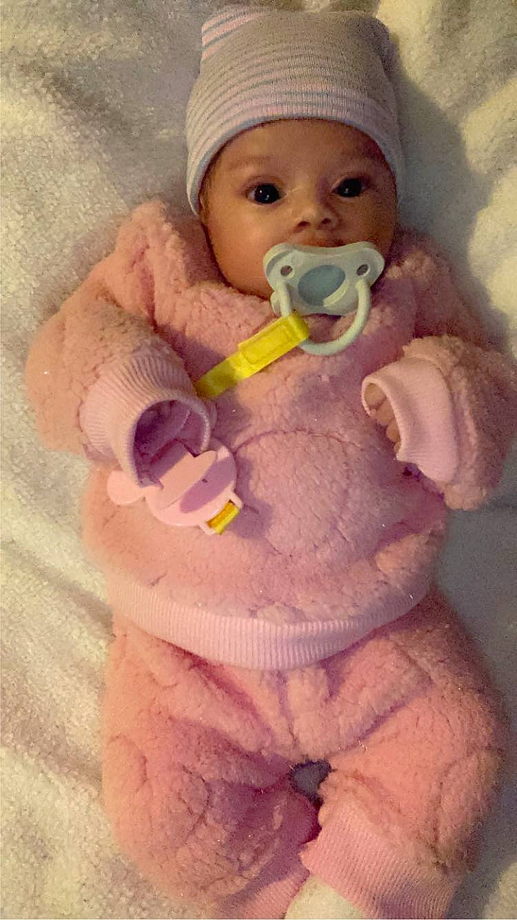 Ameya joined the competition — help win amazing prizes! baby, baby_toddler_clothing, cheek, clothing, face, gesture, hand, head, headwear, human_body, lip, mouth, nail, nose, outerwear, person, pink, skin, sleeve, thumb