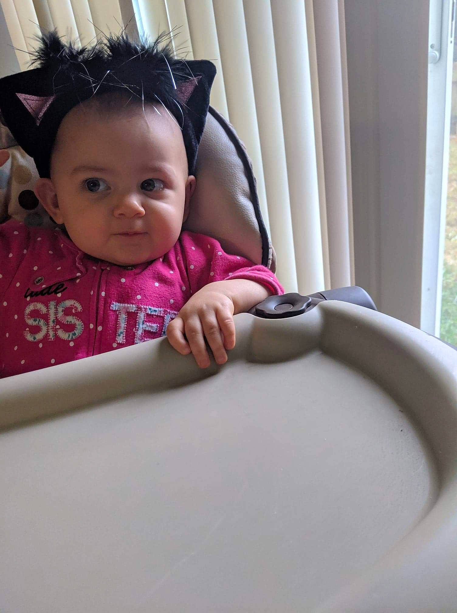 Adeline is registered to the contest to win money with this photo: baby, beauty, child, hand, person, pink, play, room, sitting, skin, smile, toddler