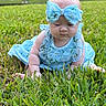 Blakeley is registered to the contest to win money with this photo: baby, child, grass, outdoor, blue_dress, headband, bow, crawling, greenery, nature, infant, cute, summer, sunlight, portrait, young_child, plains, person, skin, head
