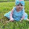Blakeley is registered to the contest to win money with this photo: baby, child, grass, outdoor, blue_dress, headband, bow, flower_pattern, cute, sitting, greenery, garden, portrait, infant, summer, nature, curious, young_child, playful, casual