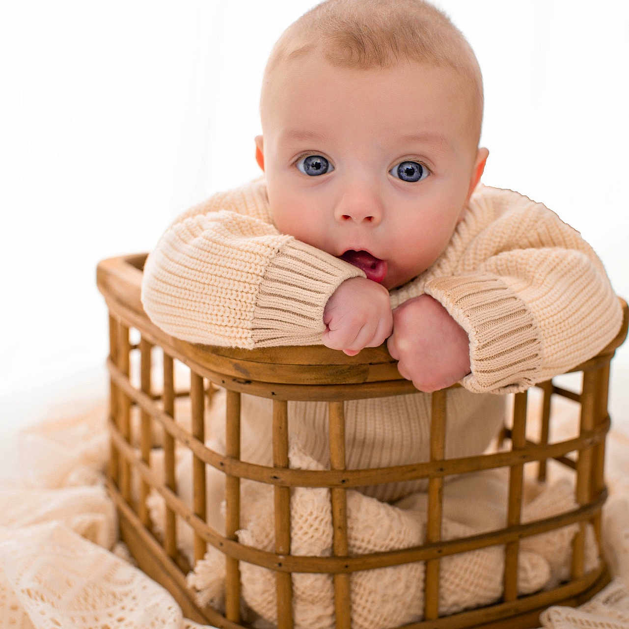 Nathan is registered to the contest to win money with this photo: baby, basket, bed, blanket, bodypart, clothing, crib, face, finger, furniture, hand, head, infantbed, knitwear, newborn, person, photography, portrait, sitting, sweater