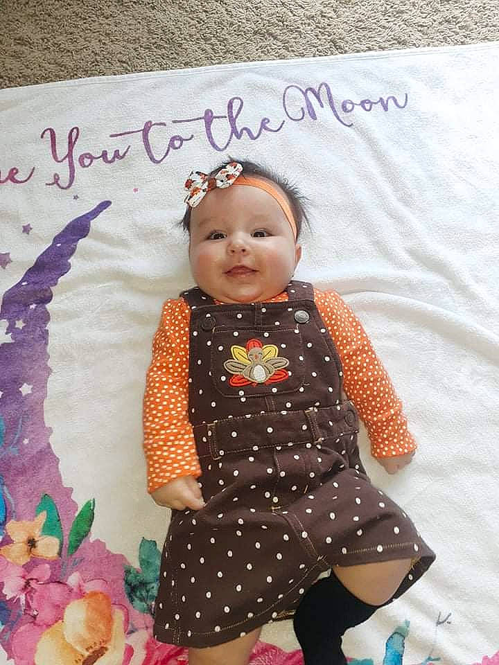 Scarlett is registered to the contest to win money with this photo: baby, baby_products, baby_toddler_clothing, child, dress, fashion_accessory, handwriting, happy, headwear, jewellery, linens, magenta, pattern, person, pink, purple, skin, sleeve, textile, toddler