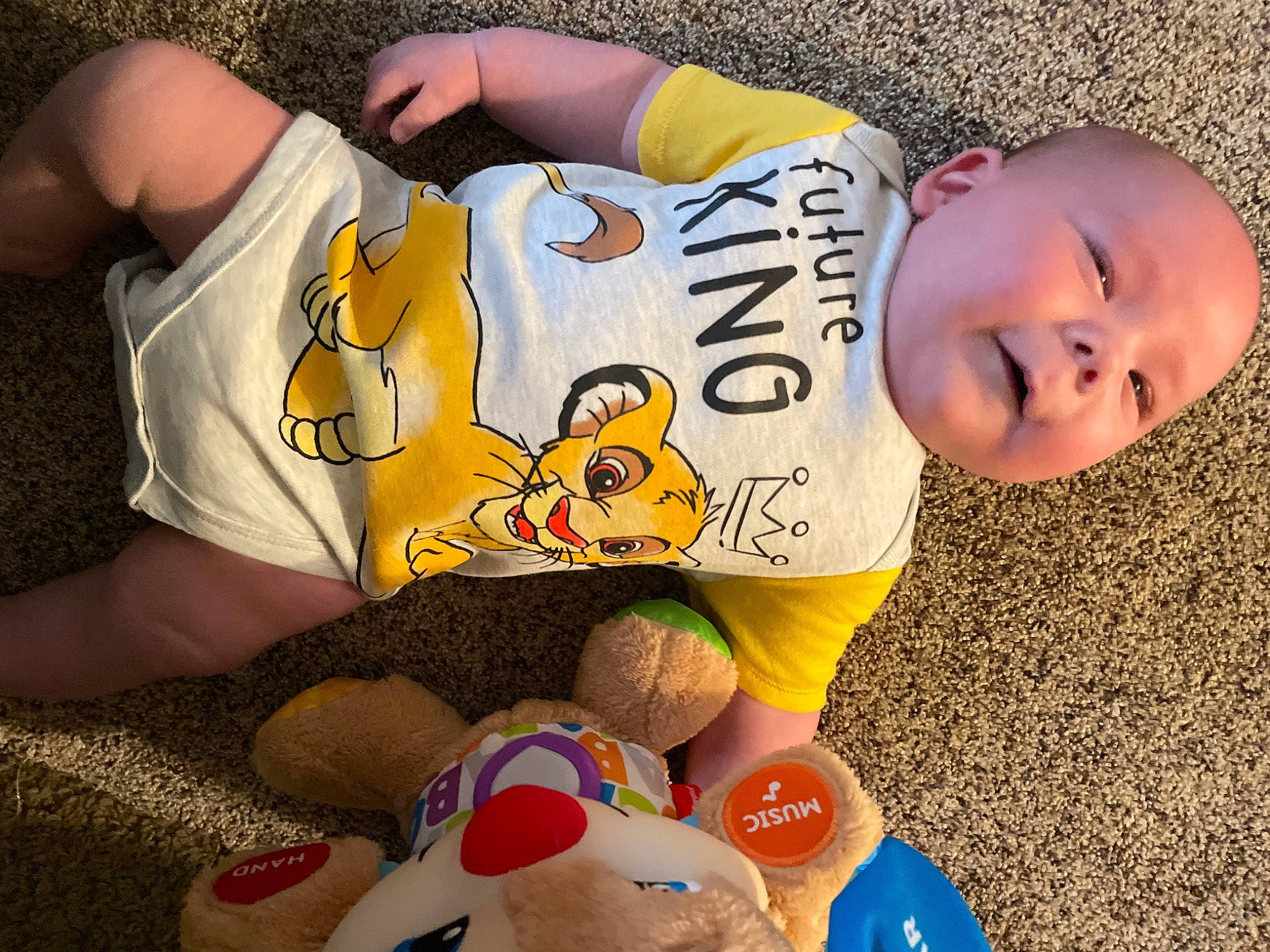 Ryder is registered to the contest to win money with this photo: arm, child, elbow, finger, fun, grass, happy, human, human_body, human_leg, organ, people, person, smile, summer, t_shirt, thigh, toddler, toy, white