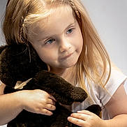 Evelina joined the competition — help win amazing prizes! child, girl, toddler, portrait, smiling, face, blue_eyes, blonde_hair, braided_hair, long_hair, teddy_bear, stuffed_animal, hugging, indoors, soft_lighting, closeup, white_shirt, hands, sitting, photography
