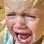 child, toddler, crying, closeup, face, emotional, blonde_hair, teeth, mouth_open, indoor, expression, upset, person, skin, head, hair, young_child, infant, human, emotion