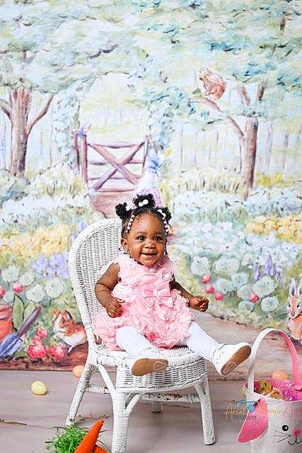 Zameena is registered to the contest to win money with this photo: art, baby, baby_toddler_clothing, chair, event, grass, happy, joy, leisure, magenta, paint, pattern, person, pink, plant, sitting, smile, spring, summer, textile