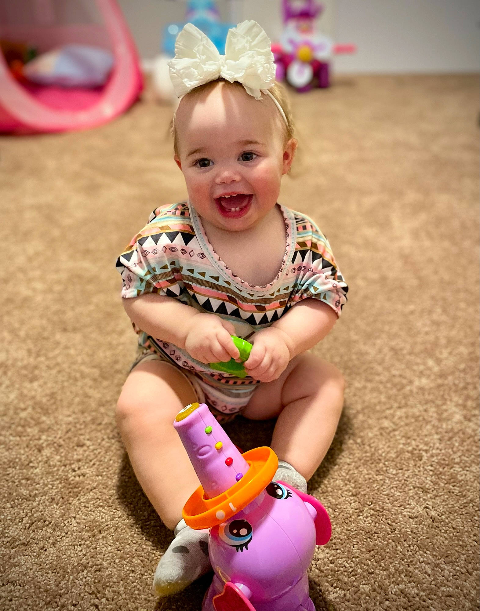 Morrelli joined the competition — help win amazing prizes! baby, baby_playing_with_toys, baby_toddler_clothing, child, face, finger, fun, grass, happy, head, human_leg, leisure, magenta, person, photograph, pink, recreation, skin, smile, toddler