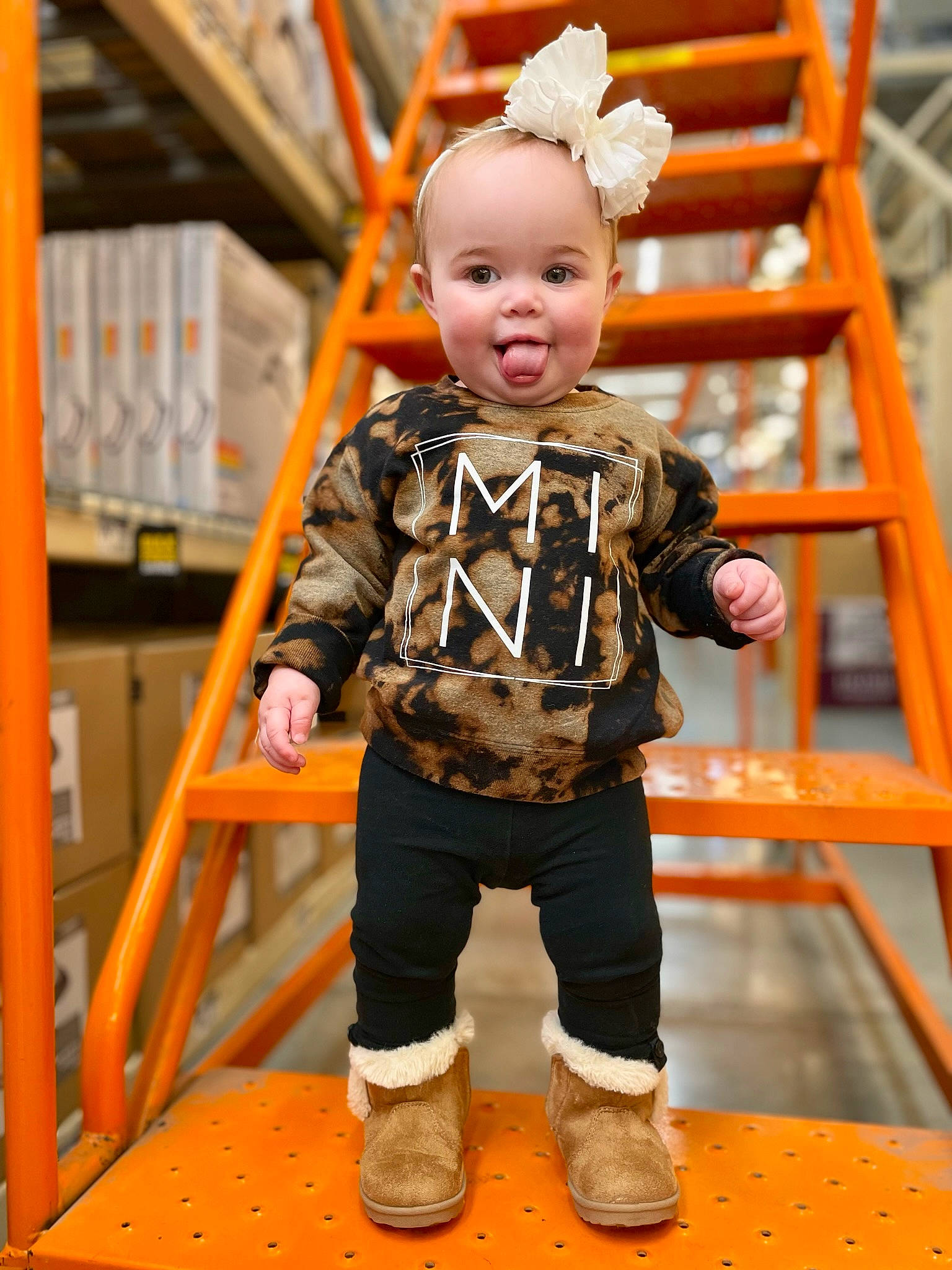 Morrelli is registered to the contest to win money with this photo: baby, baby_toddler_clothing, child, flooring, fun, happy, leisure, orange, person, room, shelf, shoe, skin, sleeve, smile, sneakers, surprise, t_shirt, toddler, toy