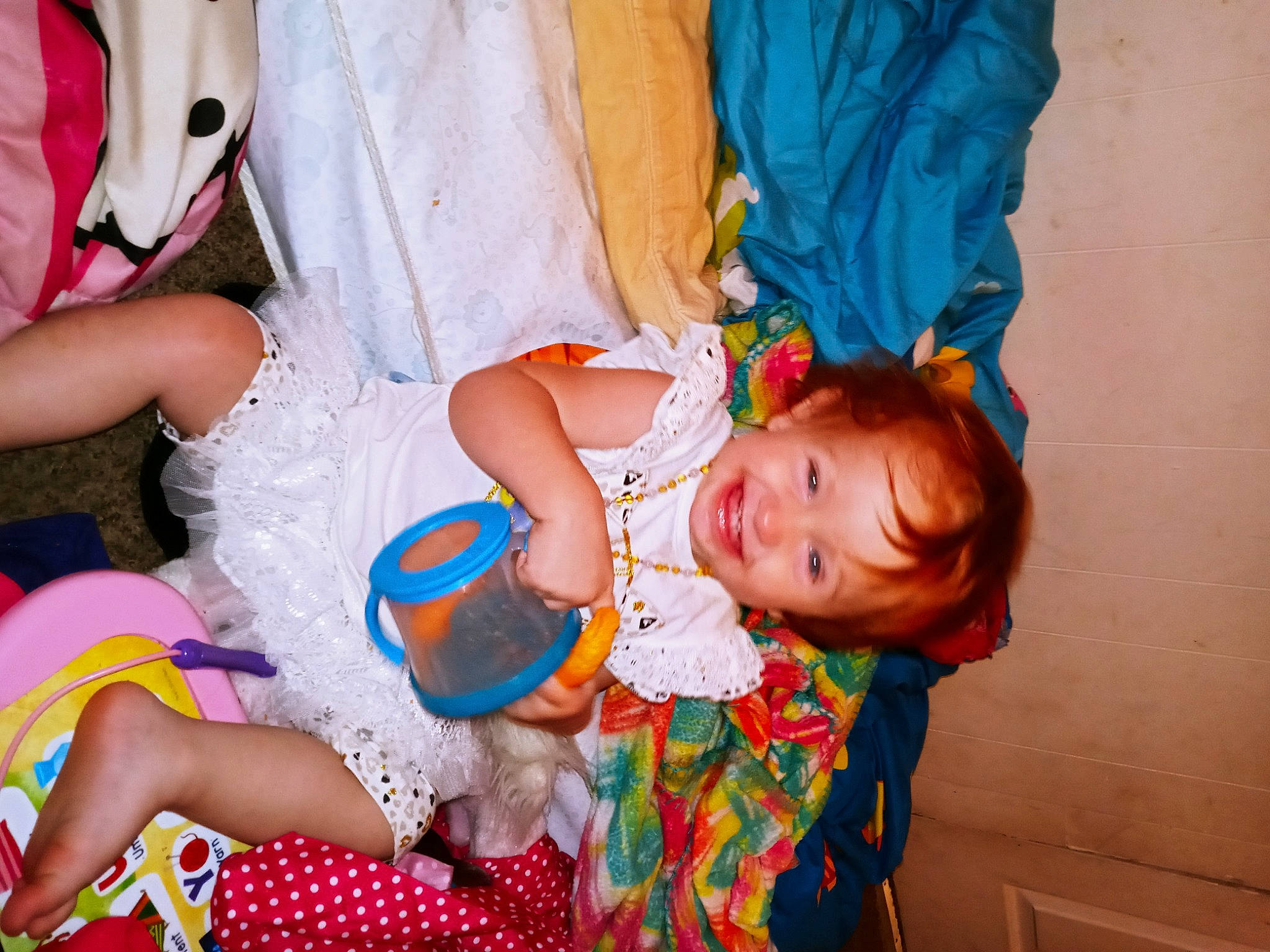 Cynthia joined the competition — help win amazing prizes! baby, baby_toddler_clothing, child, dress, event, finger, fun, happy, joy, leg, orange, person, pink, play, purple, red, sitting, skin, smile, textile