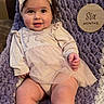 baby, infant, smiling, headband, tutu, blanket, purple, white, cute, chubby, legs, hands, face, portrait, indoor, happy, young_child, clothing, sitting, soft_texture