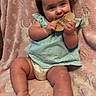 baby, infant, child, pigtails, blue_top, diaper, pink_blanket, unicorn_pattern, wooden_sign, sitting, cute, smiling, cheeks, legs, feet, hands, indoor, soft_texture, playful, portrait