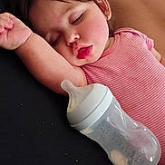 Anevay joined the competition — help win amazing prizes! toddler, sleeping, baby_bottle, pink_clothing, arm_up, resting, indoor, cute, child, peaceful, face, hair, skin, person, young_child, relaxation, infant, laying_down, cozy, quiet