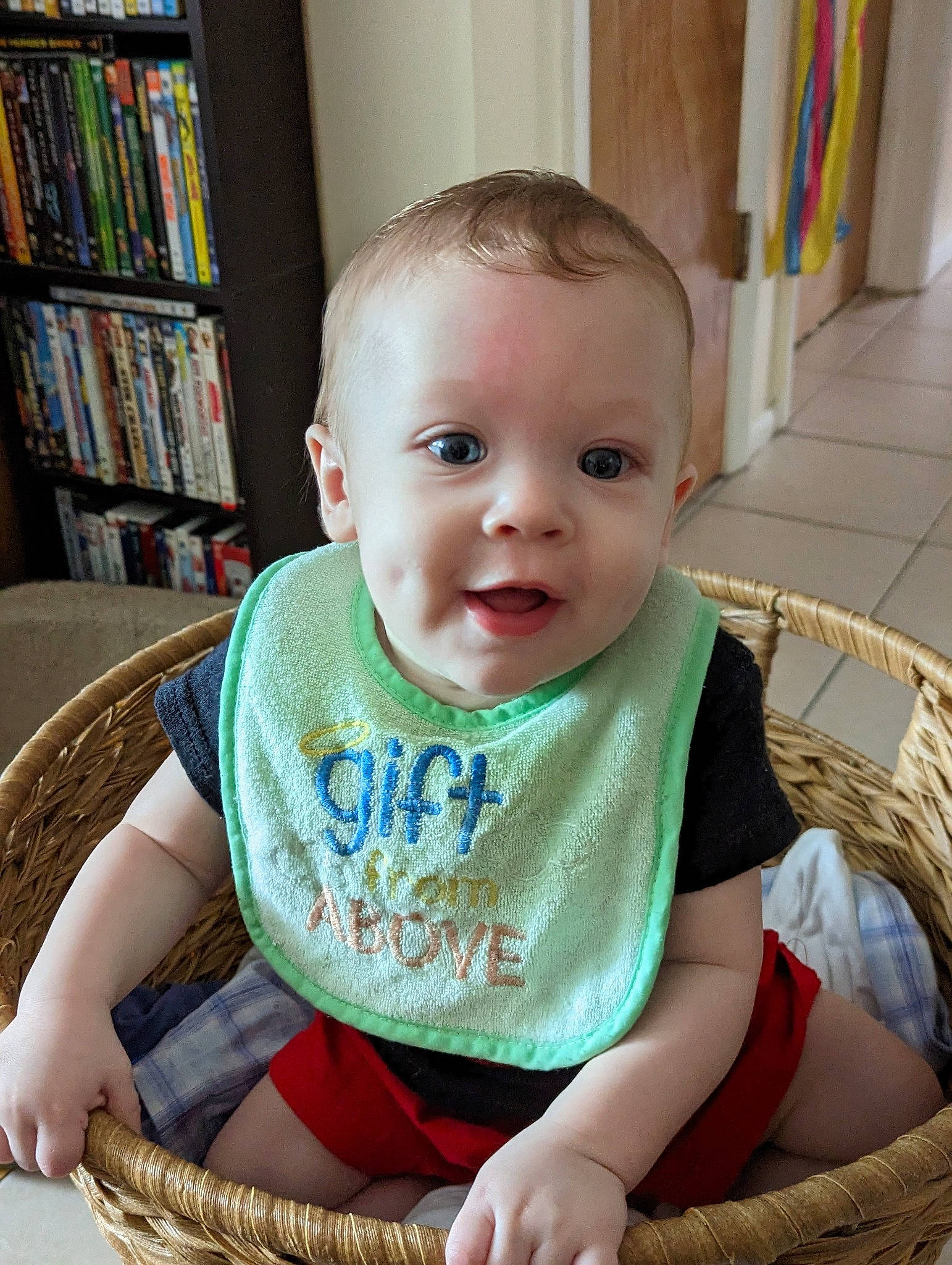 Ethan is registered to the contest to win money with this photo: baby, baby_toddler_clothing, bookcase, chair, cheek, child, eye, flooring, iris, organ, pattern, person, product, shelf, shelving, sitting, skin, sleeve, t_shirt, toddler