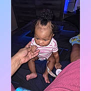 Aria joined the competition — help win amazing prizes! baby, infant, child, onesie, stripes, sitting, hand, adult_hand, pacifier_clip, bedding, bed, sock, spongebob, curly_hair, forehead, toes, bedroom, dresser, nightlight, curious_expression