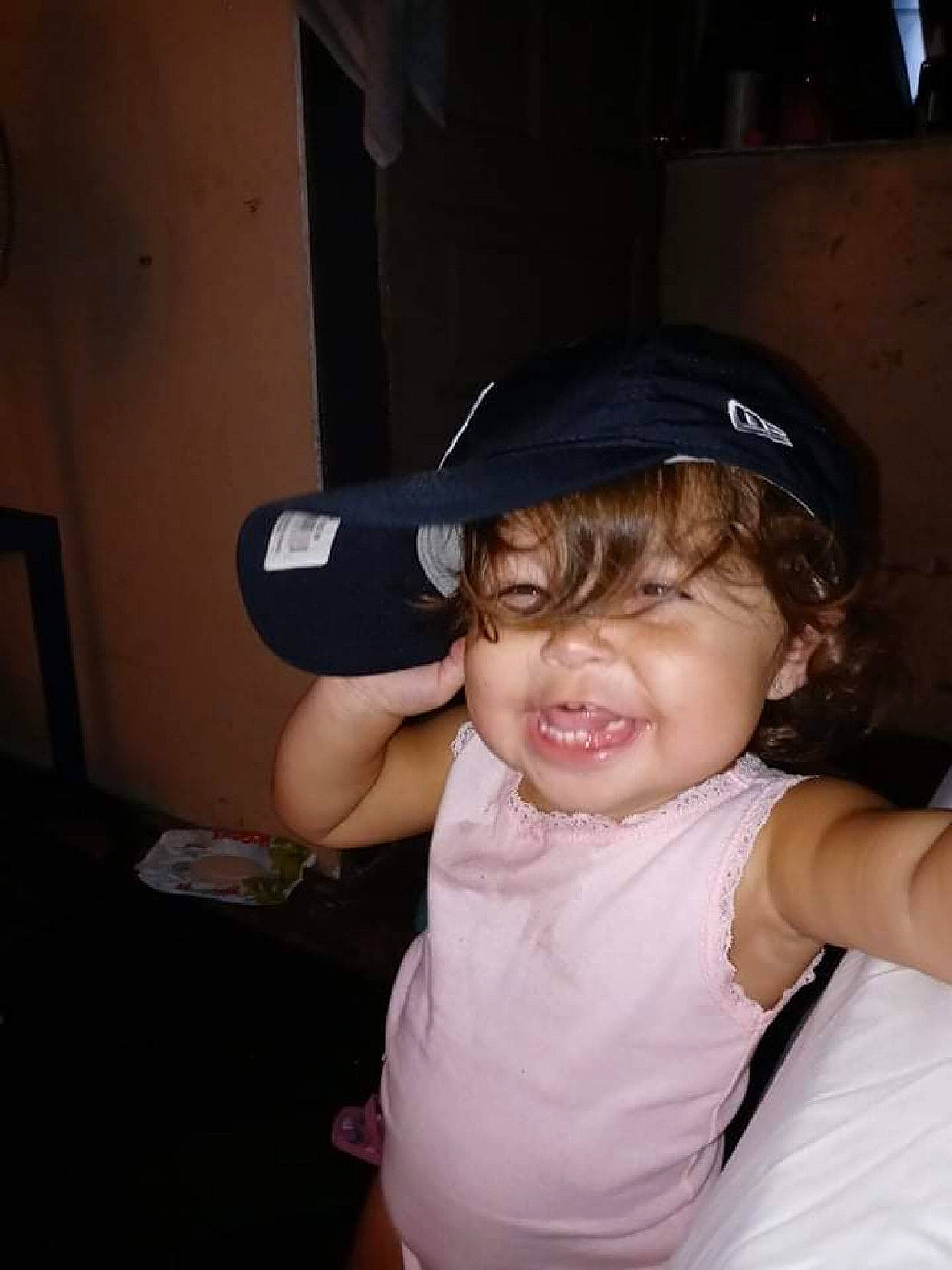 Anastacia is registered to the contest to win money with this photo: audio_equipment, baseball_cap, cap, child, electric_blue, event, eyewear, fashion_accessory, flash_photography, fun, gesture, hat, party, person, personal_protective_equipment, shoulder, sitting, sports_gear, t_shirt, thumb