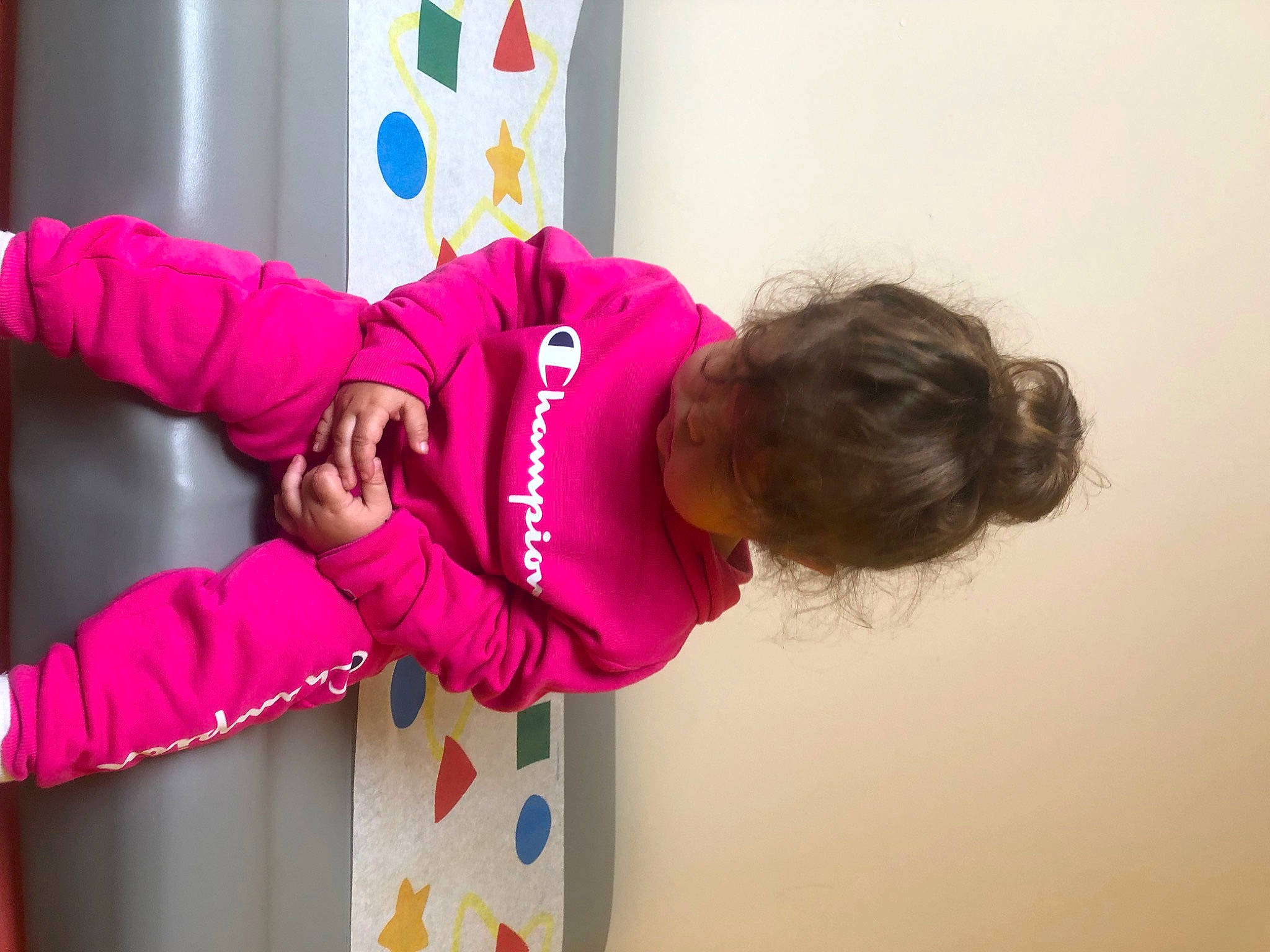 Anastacia is registered to the contest to win money with this photo: child, costume, door, elbow, event, fun, gesture, happy, magenta, person, pink, play, purple, room, sleeve, t_shirt, toddler, violet, visual_arts, window