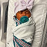baby, blanket, child, cute, hat, healthcare, hospital_bed, indoor, infant, newborn, pacifier, peaceful, person, portrait, resting, sleeping, soft, striped, swaddled, wrapped