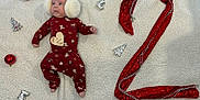 Elio participe au concours pour gagner de l'argent avec cette photo : baby, infant, earmuffs, red_pajamas, blanket, christmas_ornaments, holiday, festive, soft_texture, number_two, decorations, cute, lying_down, toddler, headwear, seasonal, celebration, warm_clothing, small_person, holiday_theme