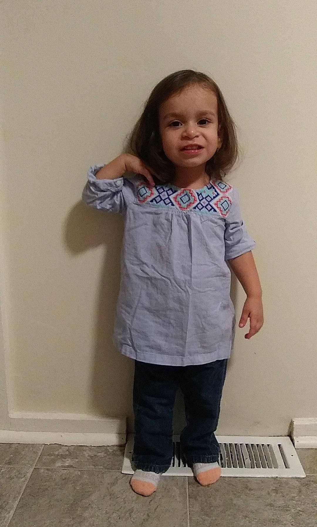 Aundrea is registered to the contest to win money with this photo: arm, baby_toddler_clothing, cheek, child, clothing, facial_expression, flooring, fun, gesture, happy, joint, neck, pattern, person, shoulder, skin, sleeve, t_shirt, toddler, waist