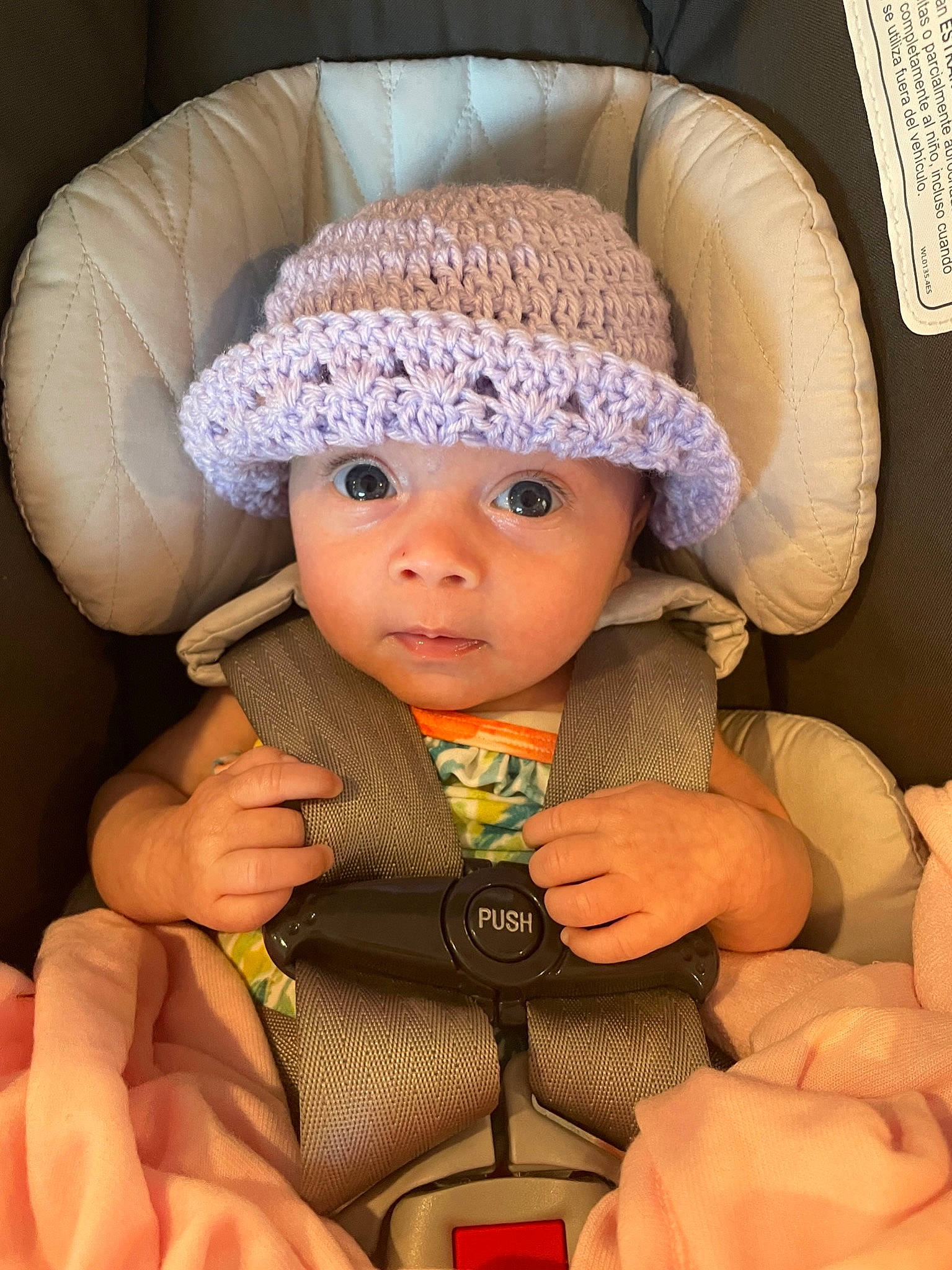 River joined the competition — help win amazing prizes! baby, baby_carriage, baby_products, baby_toddler_clothing, beanie, cap, car_seat, cheek, child, comfort, eye, fashion_accessory, headwear, human_body, knit_cap, person, sitting, skin, textile, toddler