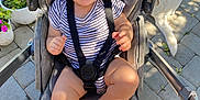 Thomas is registered to the contest to win money with this photo: baby, stroller, smiling, child, outdoor, paving_stones, flower_pot, plants, sunlight, dog, pet, happy, baby_clothing, seatbelt, legs, feet, face, person, summer, daylight